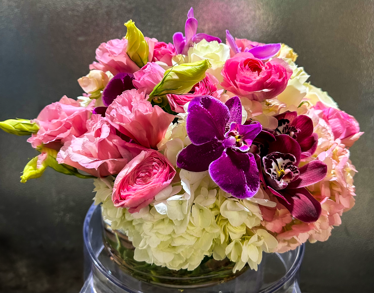 A luxurious mix of pink roses, white hydrangeas, and deep purple orchids arranged in a glass vase, ideal for upscale Houston gatherings or thoughtful gifts. Created by VIP Floristry, known for premium floral designs.