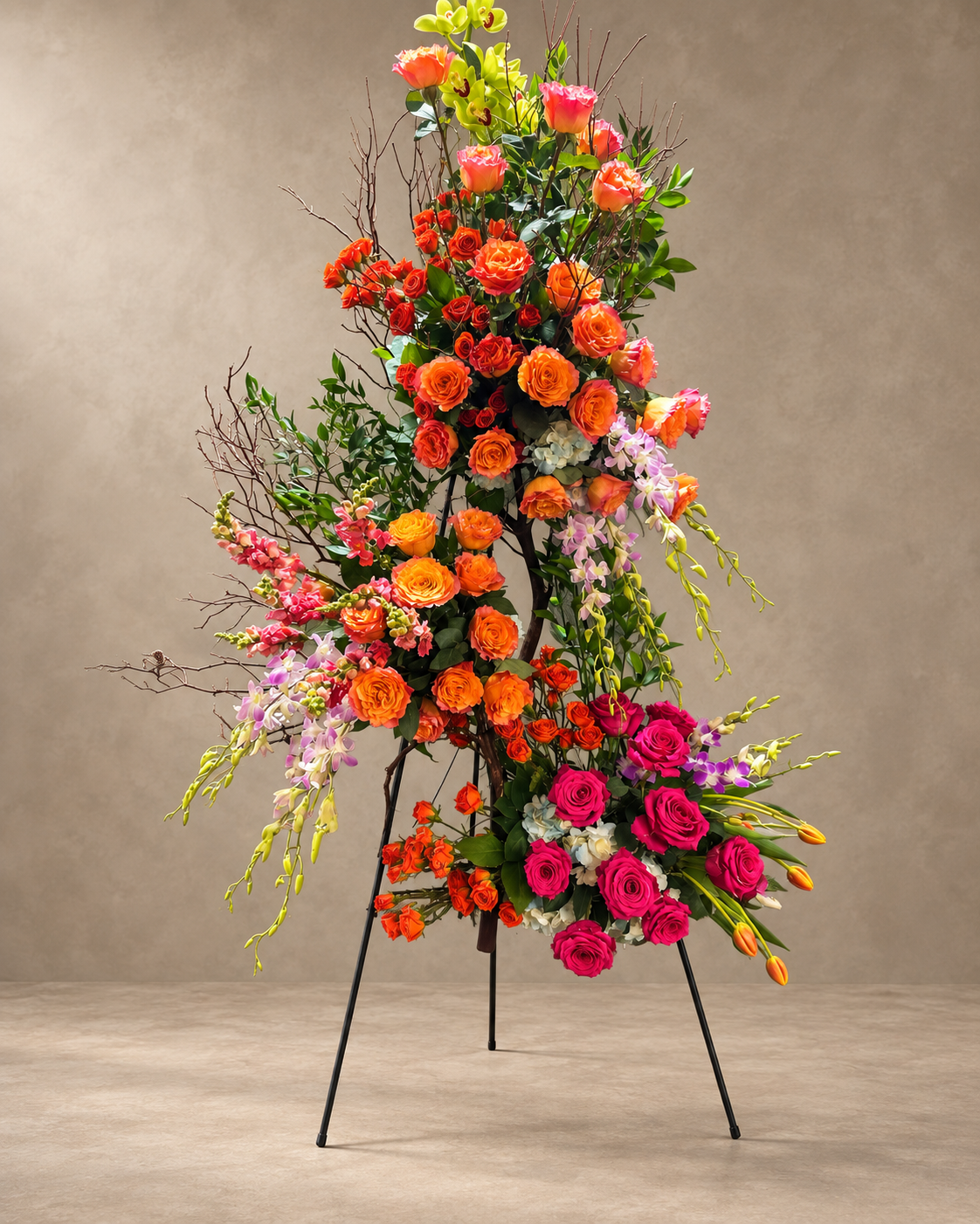Alternate view of the Manzanita Branch Clusters arrangement with orange and fuchsia roses, cascading orchids, tulip buds and sculptural branches.