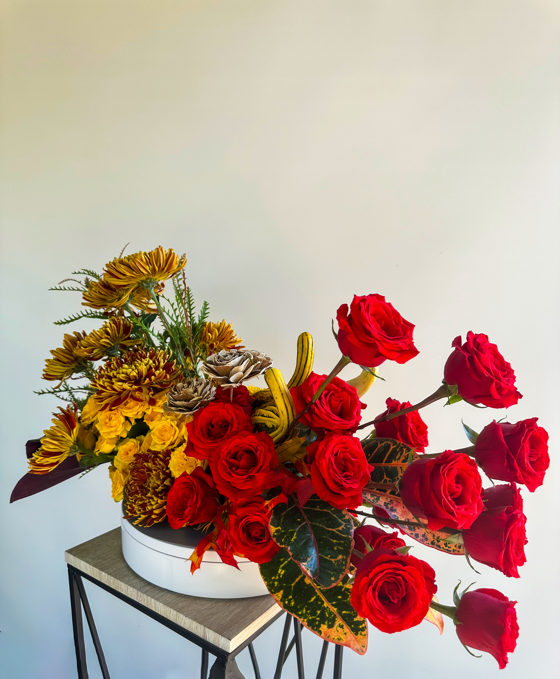 Side view of a striking arrangement with red roses and golden-yellow blooms, highlighting VIP Floristry's premium event floral services in Houston.