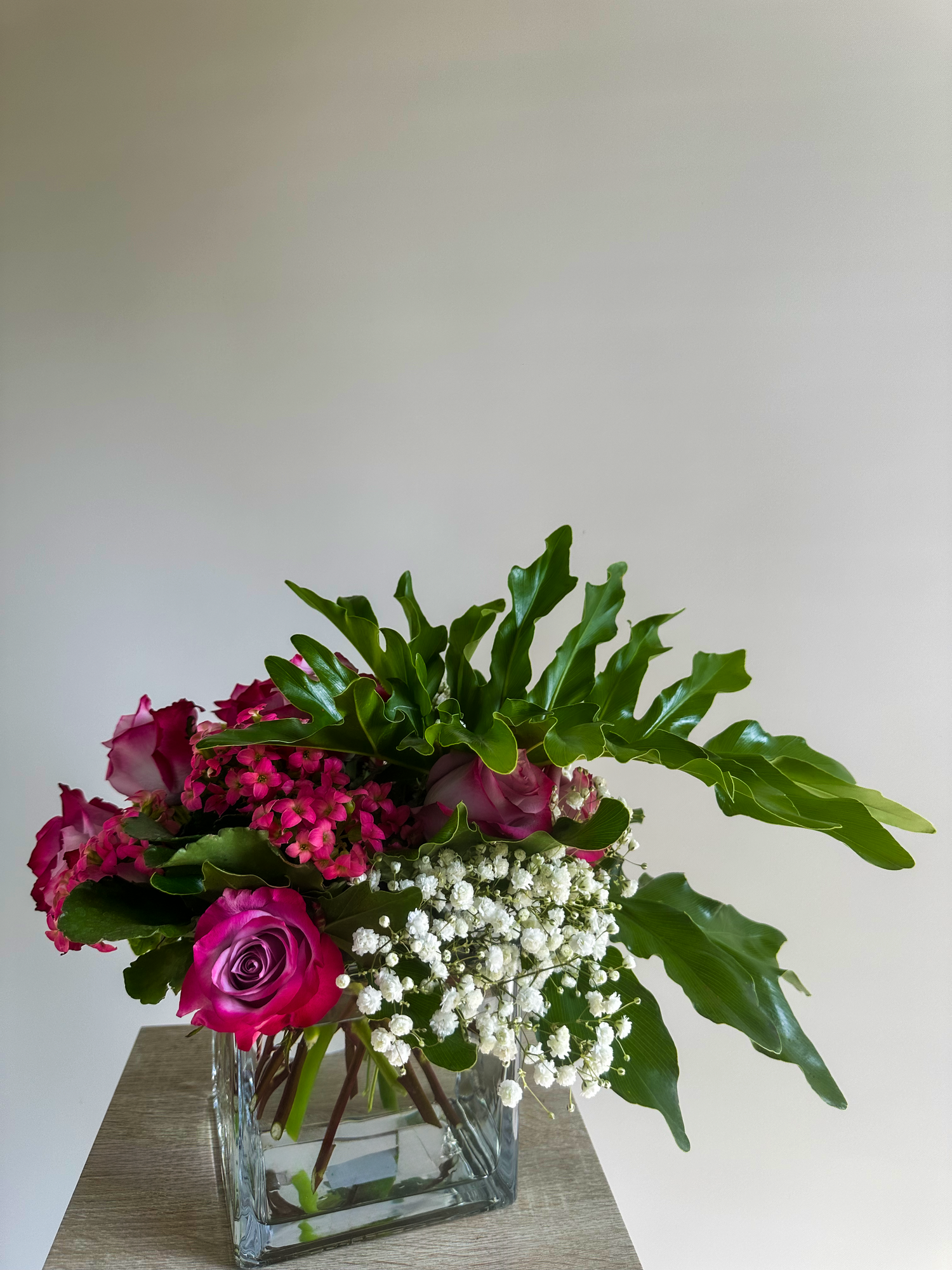 Luxury pink and white flower arrangement with greenery in a modern glass vase - VIP Floristry, Houston