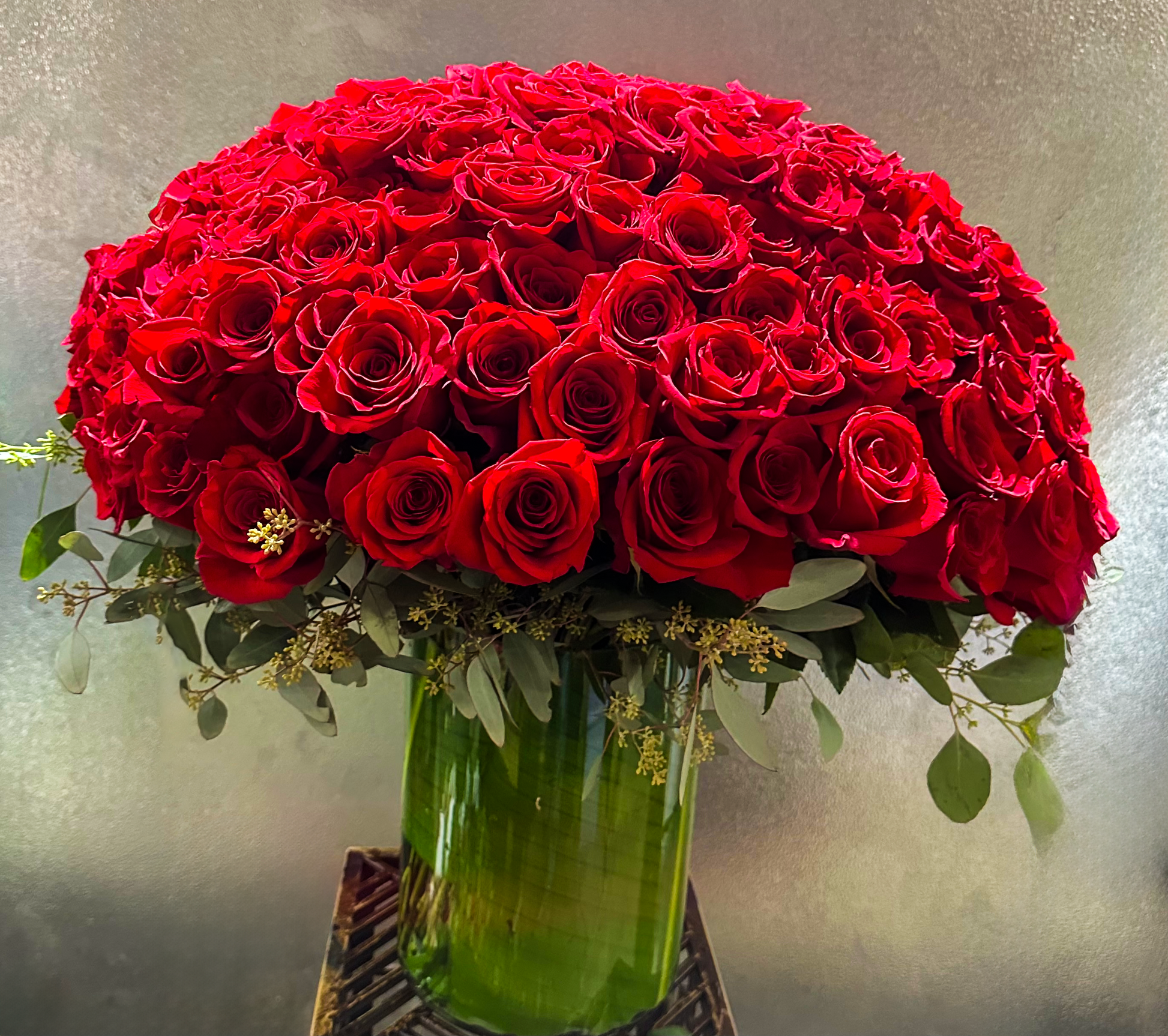 Close-up of a lush red rose arrangement in a green vase, highlighting VIP Floristry's premium flower arrangement for upscale events in Houston.